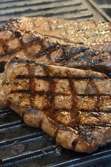 indoor grilled steak on a grill pan, showing cross marks, juicy texture
