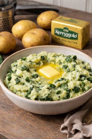bowl on Calcannon, yukon gold poates and kerrygold butter on the wood counter